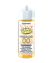 A 120ml bottle of Cinnamon Pretzel e-liquid by Loaded, with a yellow label and white cap. The e-liquid bottle has a warning label stating it contains nicotine.